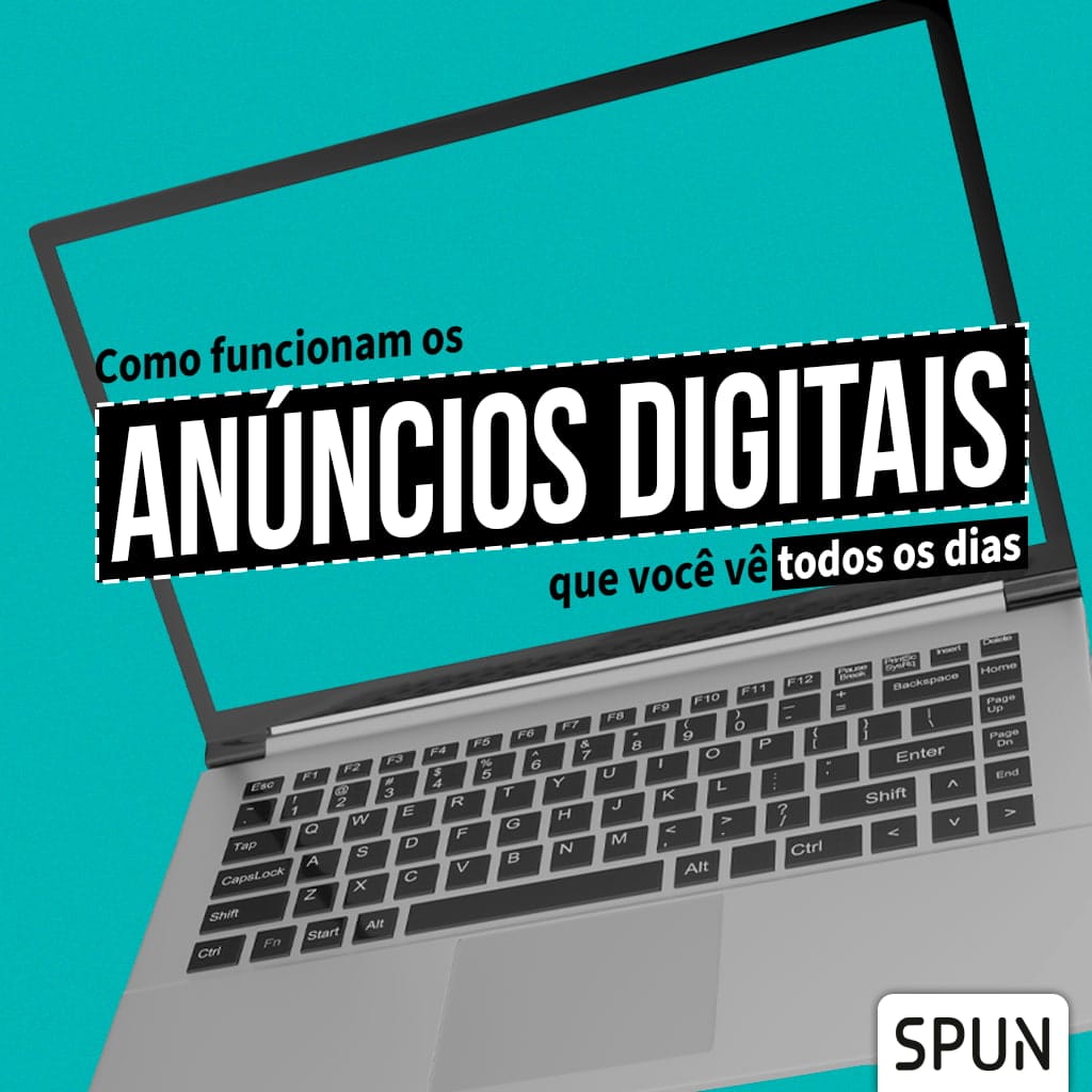 Notebook aberto com tela exibindo o título “Como funcionam os anúncios digitais que você vê todos os dias”, em destaque sobre fundo turquesa.